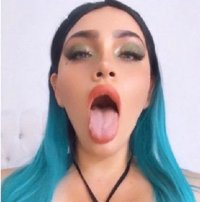 Karla Tanayry Rodriguez with Blue Hair Sticking HerTongue Out in a Face Closeup Shot.jpg