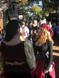 Busty Miss Lyn in a super small black corset outfit at a RenFest.jpg