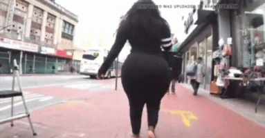 Black Lady with a Massive Booty in a Black Outfit and white Sandals Walking on a Sidewaalk in ...gif